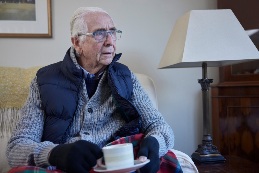 elderly man holding a cup of tea