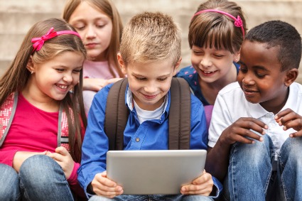 group of children around a tablet or ipad