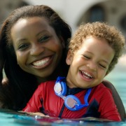 mum holding child in a swimming pool