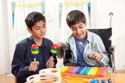 Family Fund.  Young carer helping his brother play music