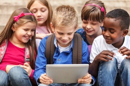 group of children around a tablet or ipad
