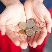 Hands held out holding coins