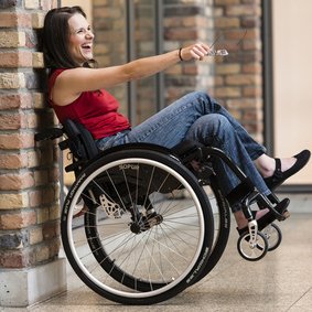 woman in manual wheelchair  being lent against the wall