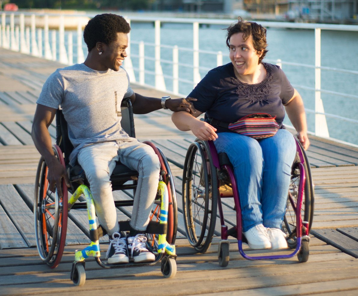 Two wheelchair users enjoying being out and about.