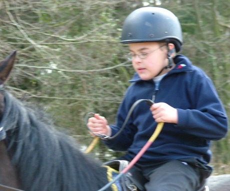 Disabled child with Cerebral Palsy horse riding at the Calvert Trust, Exmoor in Devon