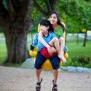 Girl on swing holding disabled brother